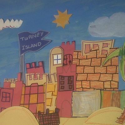 A child's drawing of a tropical island. There are paper cutouts of houses and a large palm tree layered on the island. A large blue flag reads Turney Island.