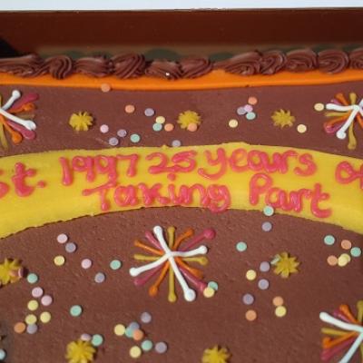 A cake with icing that reads "est. 1997 25 years of Taking Part"