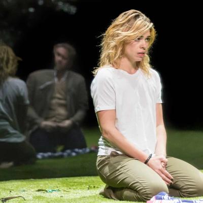 Billie Piper (Her) kneels on the grass in Yerma at the Young Vic by Johan Persson