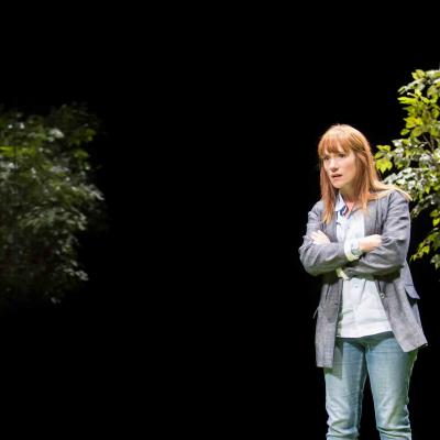 Charlotte Randle (Mary) stands between two trees in Yerma at the Young Vic. Photo by Johan Persson
