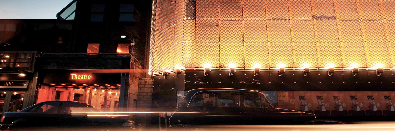 Long exposure of car going past the Young Vic on The Cut, leaving a light trail from its headlights. Photo by Philip Vile.