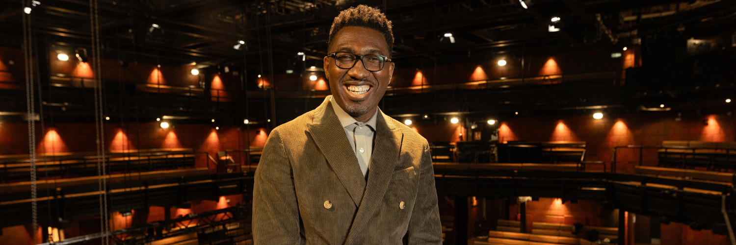 Kwame Kwei-Armah in a green double breasted, corduroy suit.
