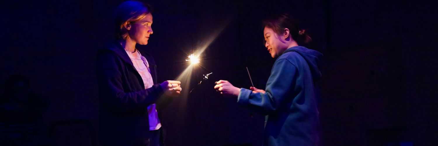 Two people holding sparklers