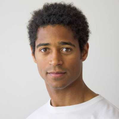 A headshot of Alfred Enoch