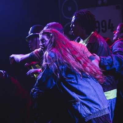 A group of people pushing each other and shouting 