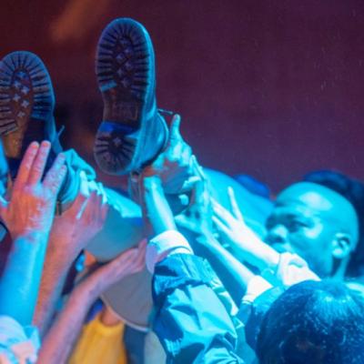 A group lifting up woman in the air. The American Dream 2.0 Photo by Anthony Lee