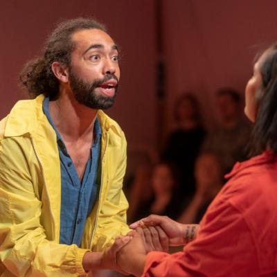 Man holding hands with woman pleading. The American Dream 2.0 Photo by Anthony Lee