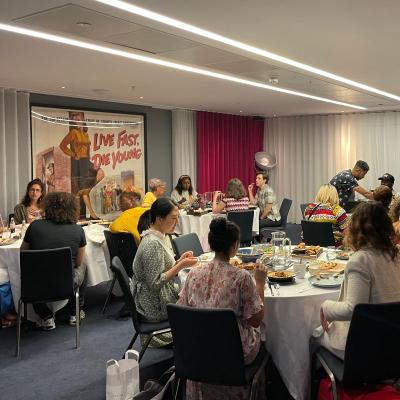 A room with tables with people sat around them.