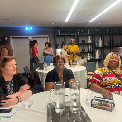 3 women sat around a table.