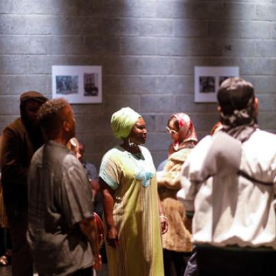 A group of people in a studio space with pictures stuck on the walls