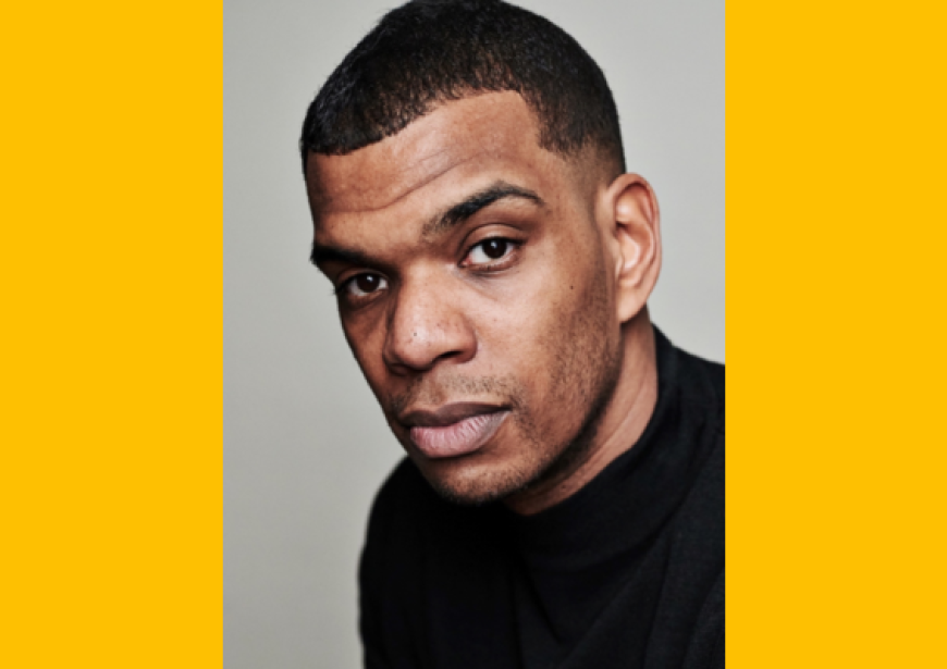 A headshot of a Black man with short hair.