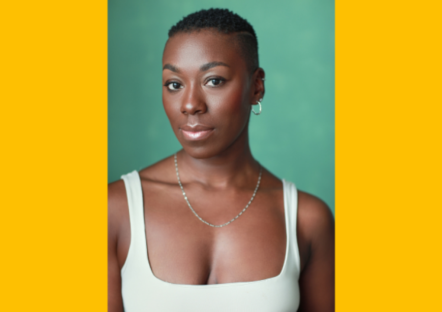 A headshot of a person with short cropped hair in a cream singlet
