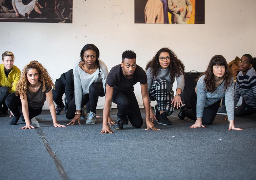 Directors in a workshop, crouching poised as if starting a race