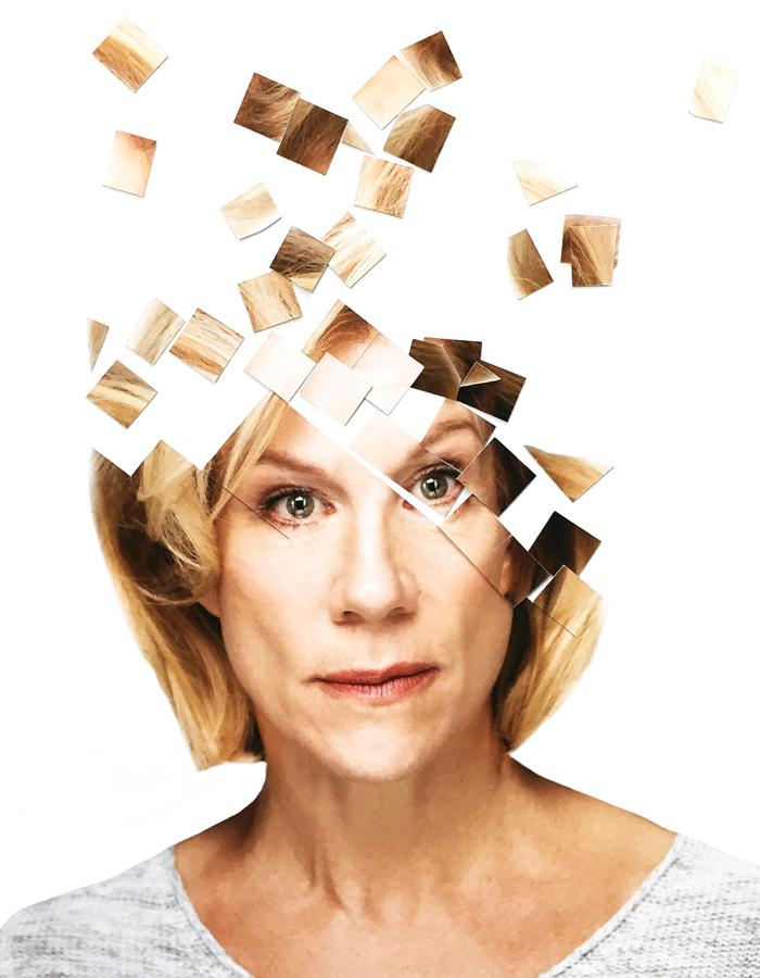 Portrait of Juliet Stevenson in front of a white background with the top of her fragmented into square puzzle pieces 