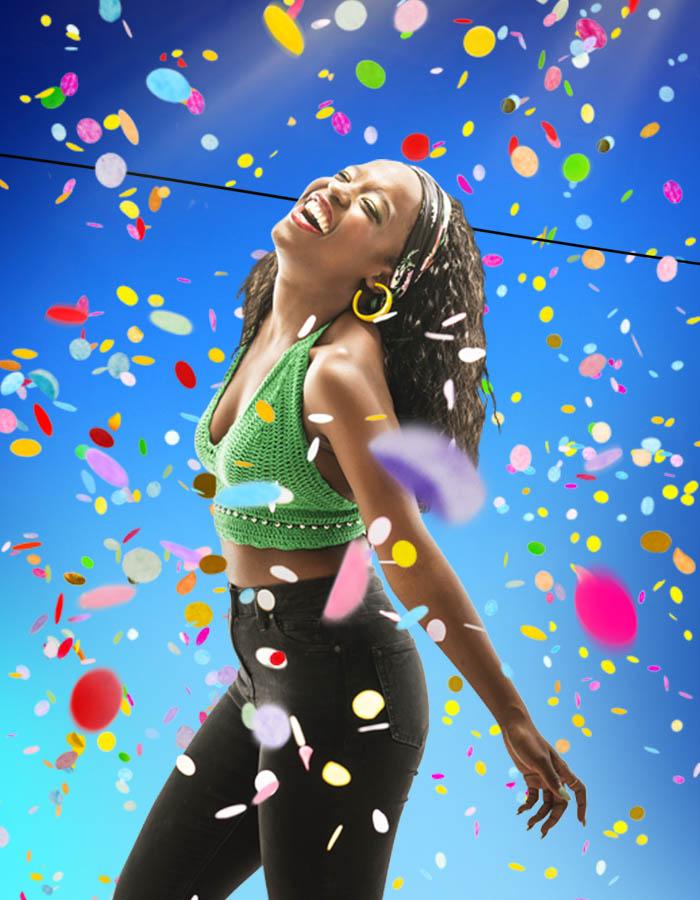 Gabrielle Brooks (Viola) stands under a shower of bright multi-coloured confetti