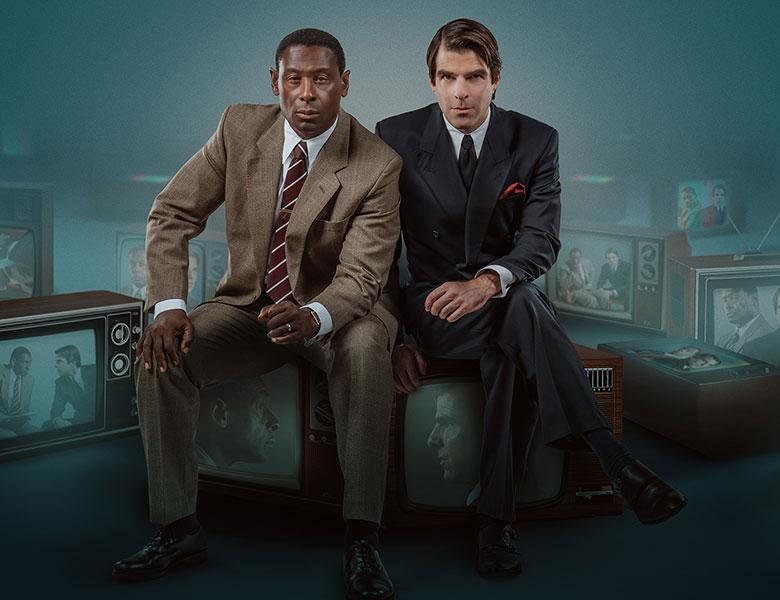 Best of Enemies West End. From 14th November 2022 to 18th February 2023. Image description: Two men in suits, sat side by side, on a number of TVs with their faces on the screen. The words "Best of Enemies' are in white in the center right of the image. 