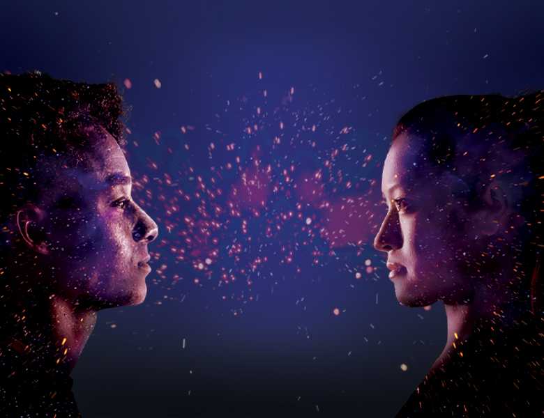 The side profiles of two people looking at each other on a purple background with sparks between them. 