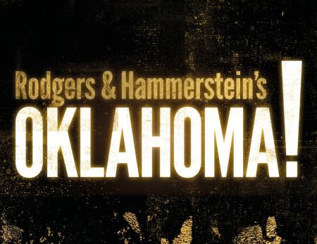 A black background with gold flecks The words Rodgers & Hammerstein's are in gold above the world Oklahoma! in white