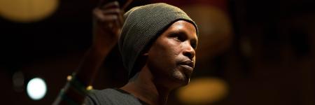 A close up portrait of a performer on stage during Go Between. Photo by Jordan Lee. 