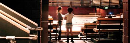 Two young people seen through the door to the main auditorium. Picture by Philip Vile 