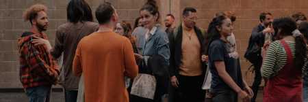 A group of artists speaking to one another in a networking event