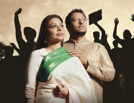 Chasing Hares. From 16th July to 13th August 2022. Image description:  Irfan Shamji and Ayesha Dharker both standing with chins raised, looking into the distance. Behind them there are crowds of people with arms raised as if protesting, with the sky visible in the background.