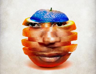 A black man's face embedded into an orange which has been cut and stacked in long slices with blue discoloration on top of the orange 