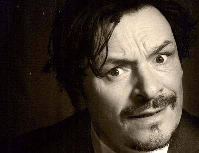 Julian Barratt looks quizzically at the camera . 