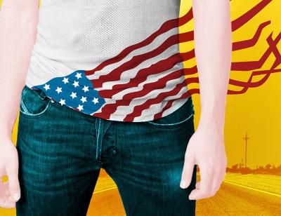 A man's body in jeans with a white singled and the american flag streaming out of his jeans